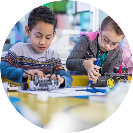 Children manipulating robotic toys