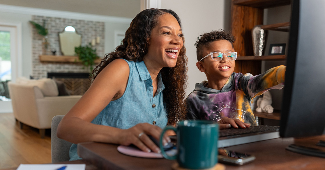 Parent and student working together on a computer at home, highlighting the flexibility and connection through Florida Virtual School.