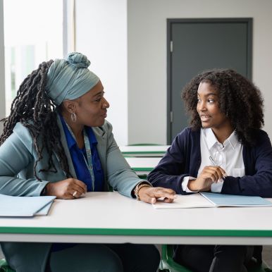 Teacher at Florida Scholars Academy teaches middle school student at a desk