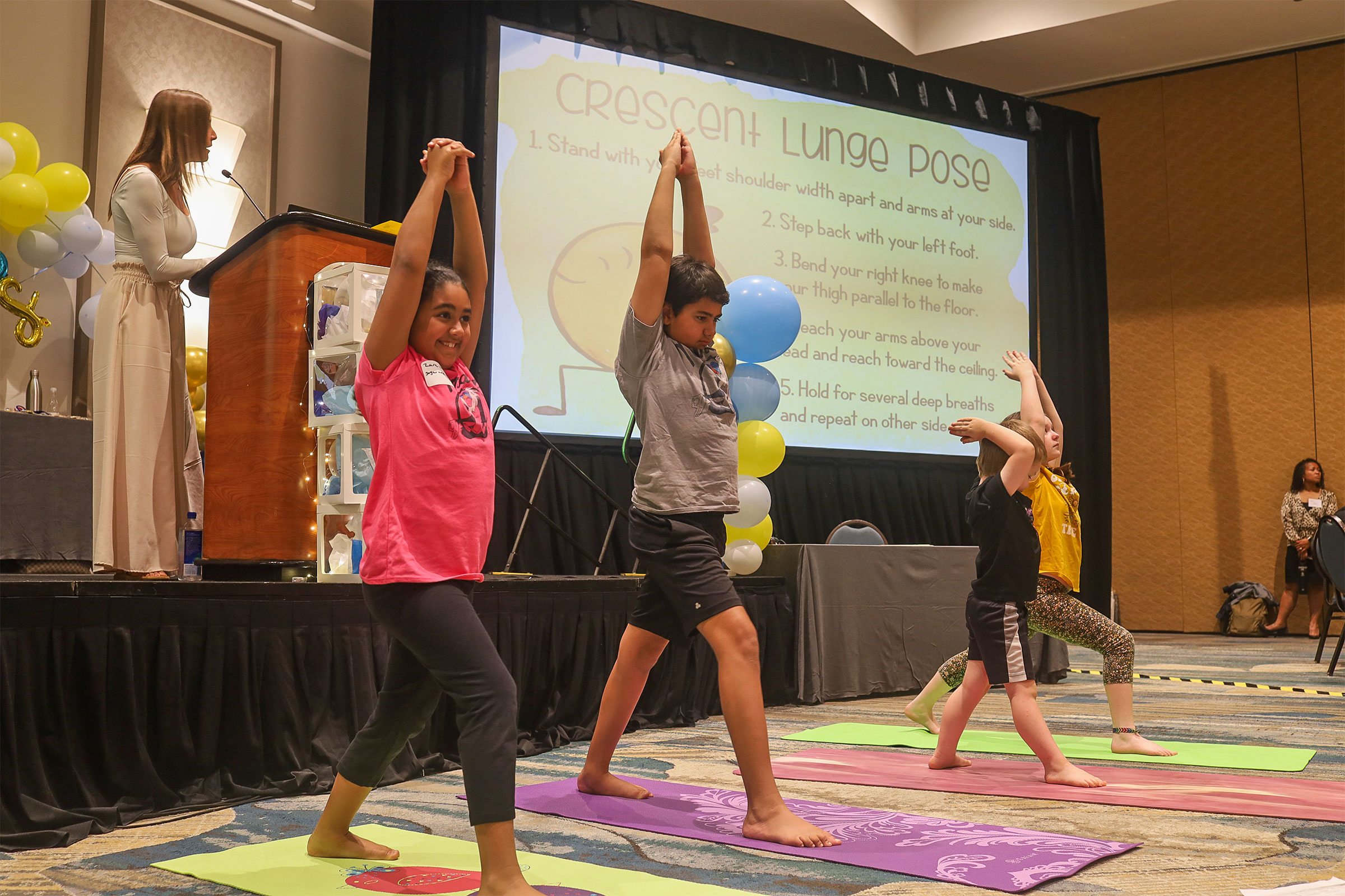 Mindfulness and Yoga Club demonstrating the crescent lunge pose