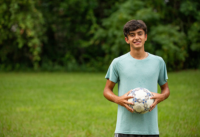 FLVS student holding a soccer ball